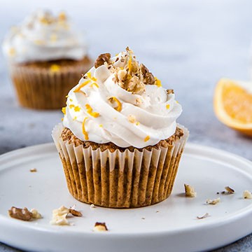 Carrot muffins with orange crème frosting